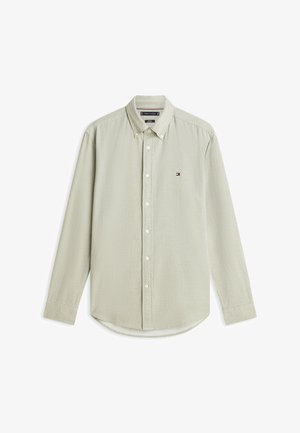 Lichtbeige overhemd met lange mouwen, subtiel patroon, klein geborduurd logo op de borst en een button-down kraag.