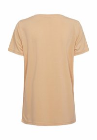 Perzikkleurige T-shirt met korte mouwen, ronde hals, gemaakt van zachte stof. Eenvoudig ontwerp zonder zichtbare patronen of accenten. Eenvoudige achterkant.