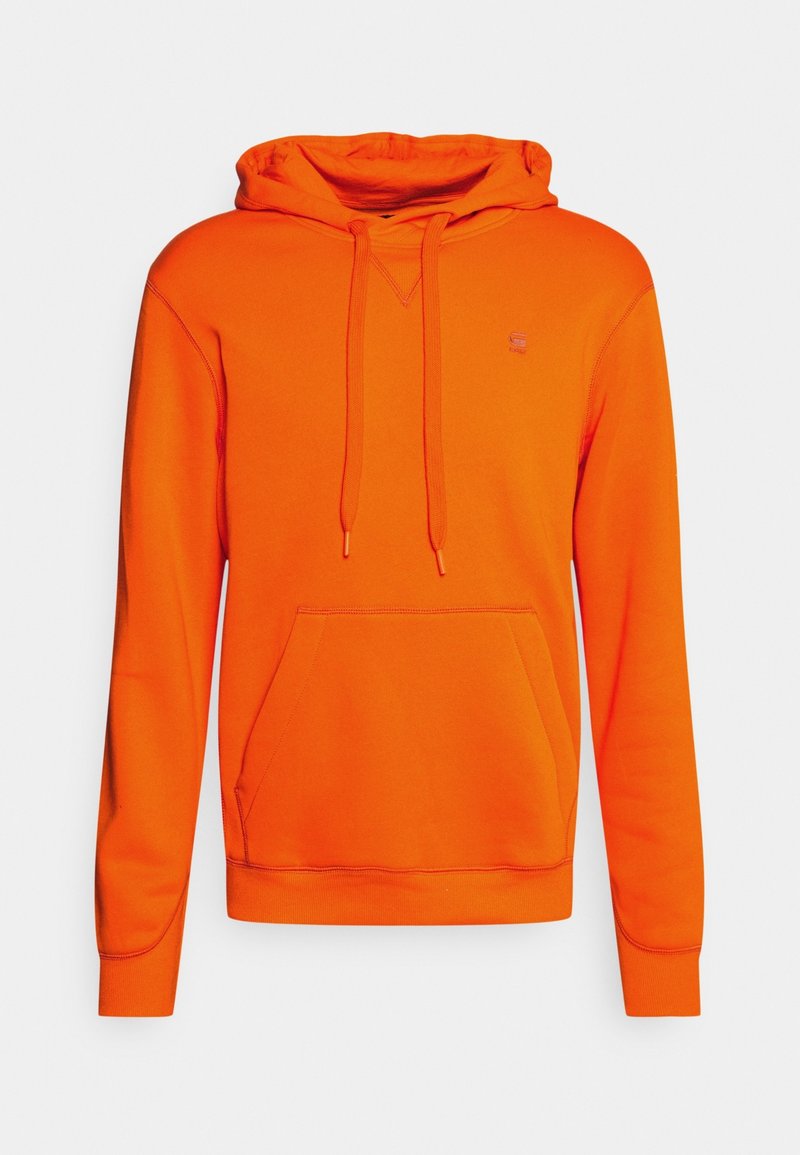 Sweat à capuche orange vif avec poche kangourou avant et cordon de serrage à la capuche, présenté sur un fond neutre.