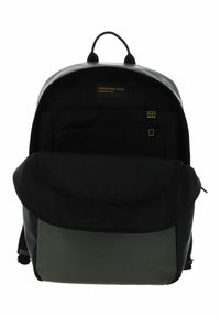 Sac à dos noir avec une finition lisse, doté d'un panneau inférieur vert, d'une fermeture éclair et d'une poche à rabat à l'avant. Étiqueté "Mandarina Duck."