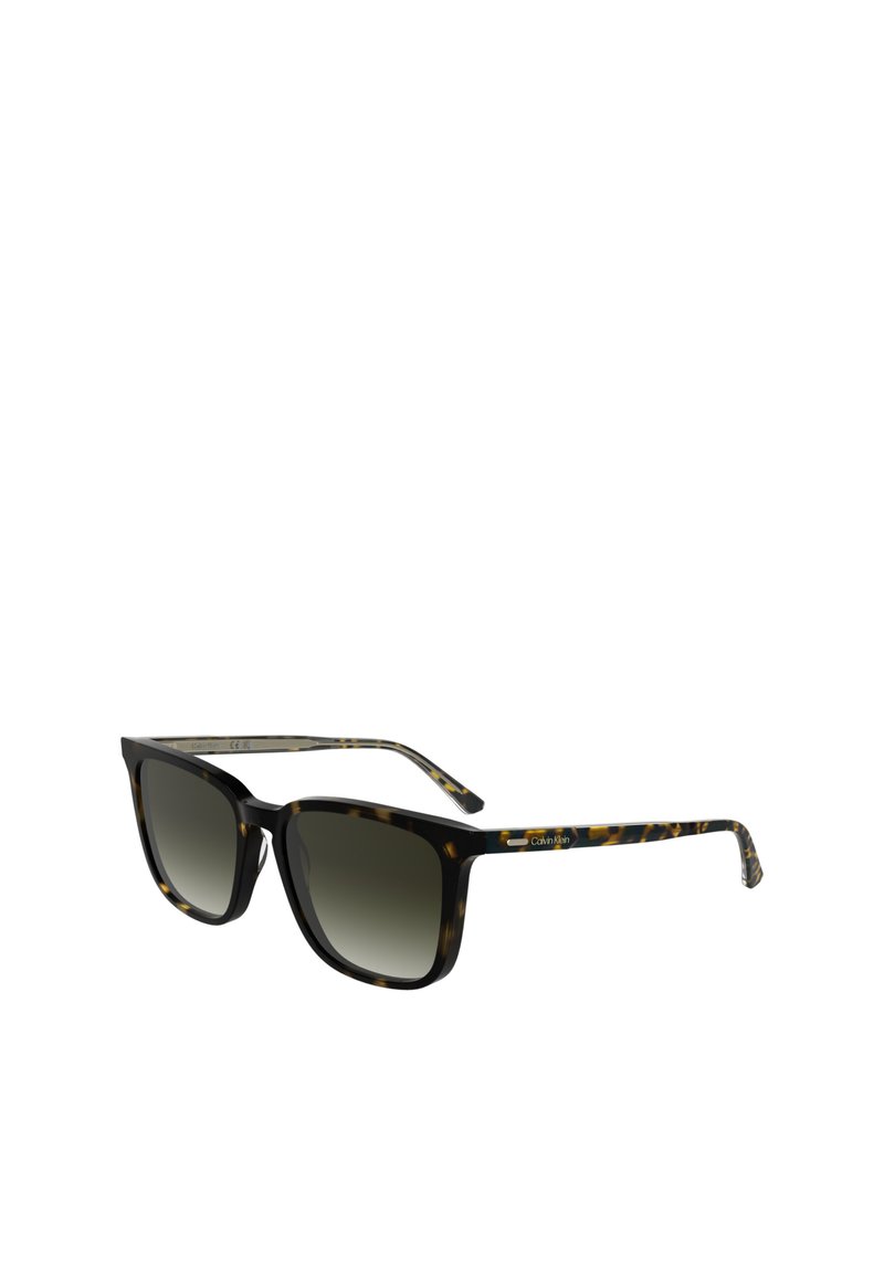 Skilpadde-sunglasses med klassisk firkantet form, gradient grå linser og gullacetatdetaljer på templene. Calvin Klein-merke til stede.
