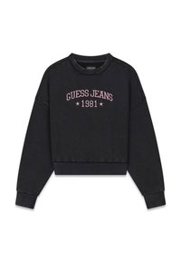 Czarna krótka bluza z bawełny z prążkowanymi ściągaczami na mankietach i u dołu. Na przodzie różowy haft "GUESS JEANS 1981" oraz dwie gwiazdki.