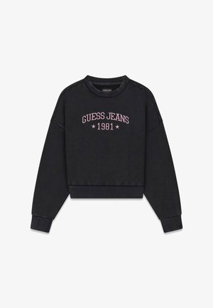 Musta lyhyt puuvillainen collegepaita, jossa on resoriset hihansuut ja helma. Varustettu vaaleanpunaisella kirjailulla, jossa lukee "GUESS JEANS 1981" ja kaksi tähteä.