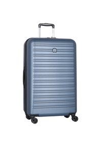 Valigia rigida di un blu profondo con un design testurizzato e a righe. Dotata di maniglia retrattile e quattro ruote a sfera per una maggiore mobilità.