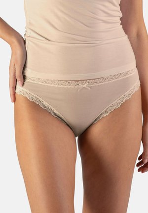 Beige Baumwollpantys mit Spitzenbesatz, versehen mit einer Schleifendetail an der Vorderseite und einer weichen, glatten Textur. Hochgeschnittenes Design für zusätzlichen Komfort.