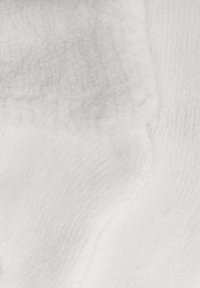 White fabric featuring a soft, plush texture with visible loops and smooth sections. Interwoven patterns create a dimensional appearance.