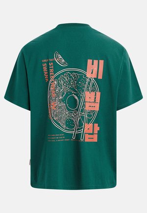 Green cotton t-shirt featuring a graphic of a bowl of bibimbap, with orange text and white outlines, short sleeves, and a crew neckline.