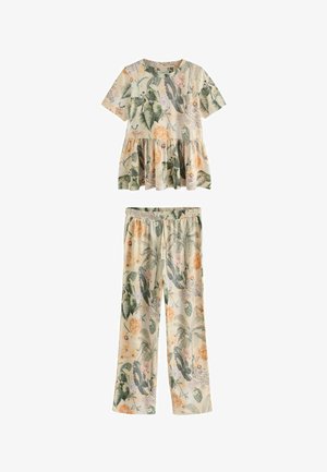 Kortærmet peplum-top og bukser med elastisk talje og lige ben med beige baggrund og grønne og orange tropiske bladprint.