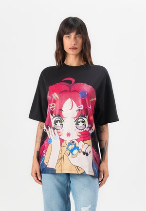 Black oversized t-shirt featuring a colorful graphic print of a character with red hair, stars, and playful designs. Made from soft cotton.