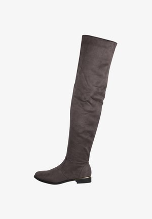 Bottes en suède gris montantes avec un bout arrondi, un petit talon carré et une texture lisse. Dotées d'un accent doré près du talon.