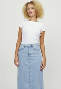 White short-sleeve fitted t-shirt paired with a high-waisted light blue denim maxi skirt, featuring button closure and side pockets.