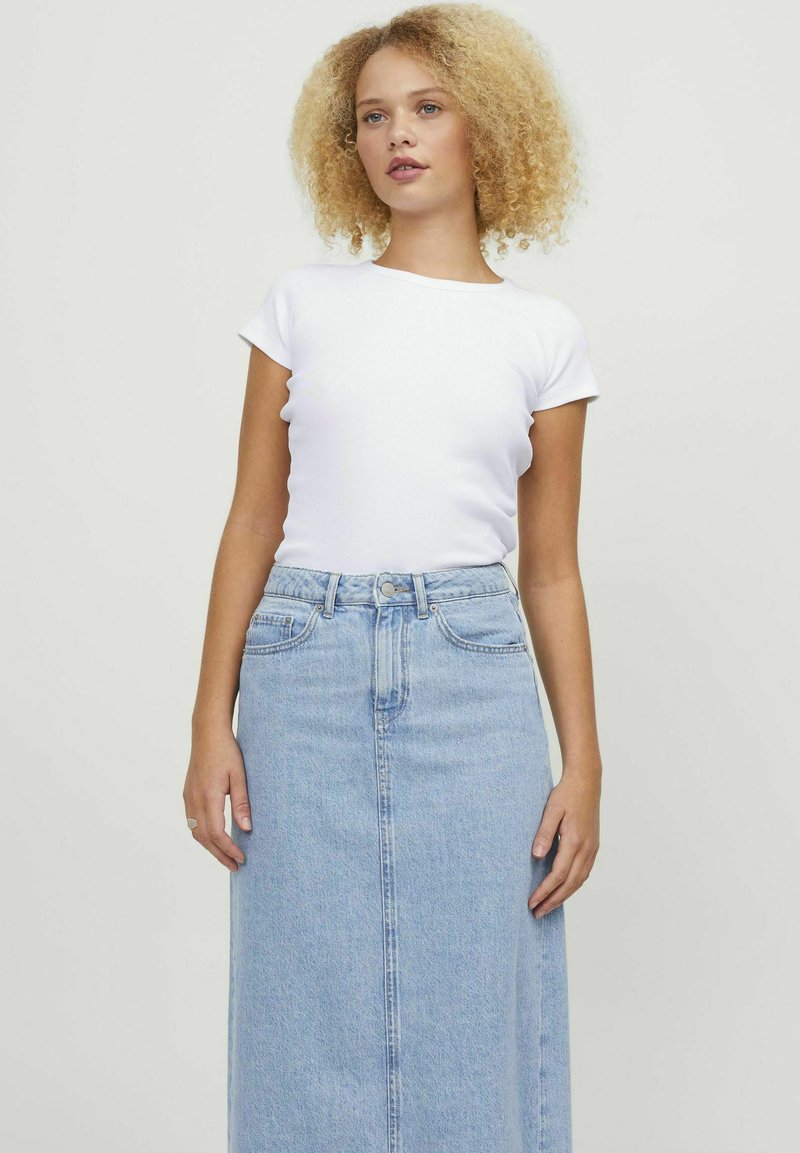 White short-sleeve fitted t-shirt paired with a high-waisted light blue denim maxi skirt, featuring button closure and side pockets.