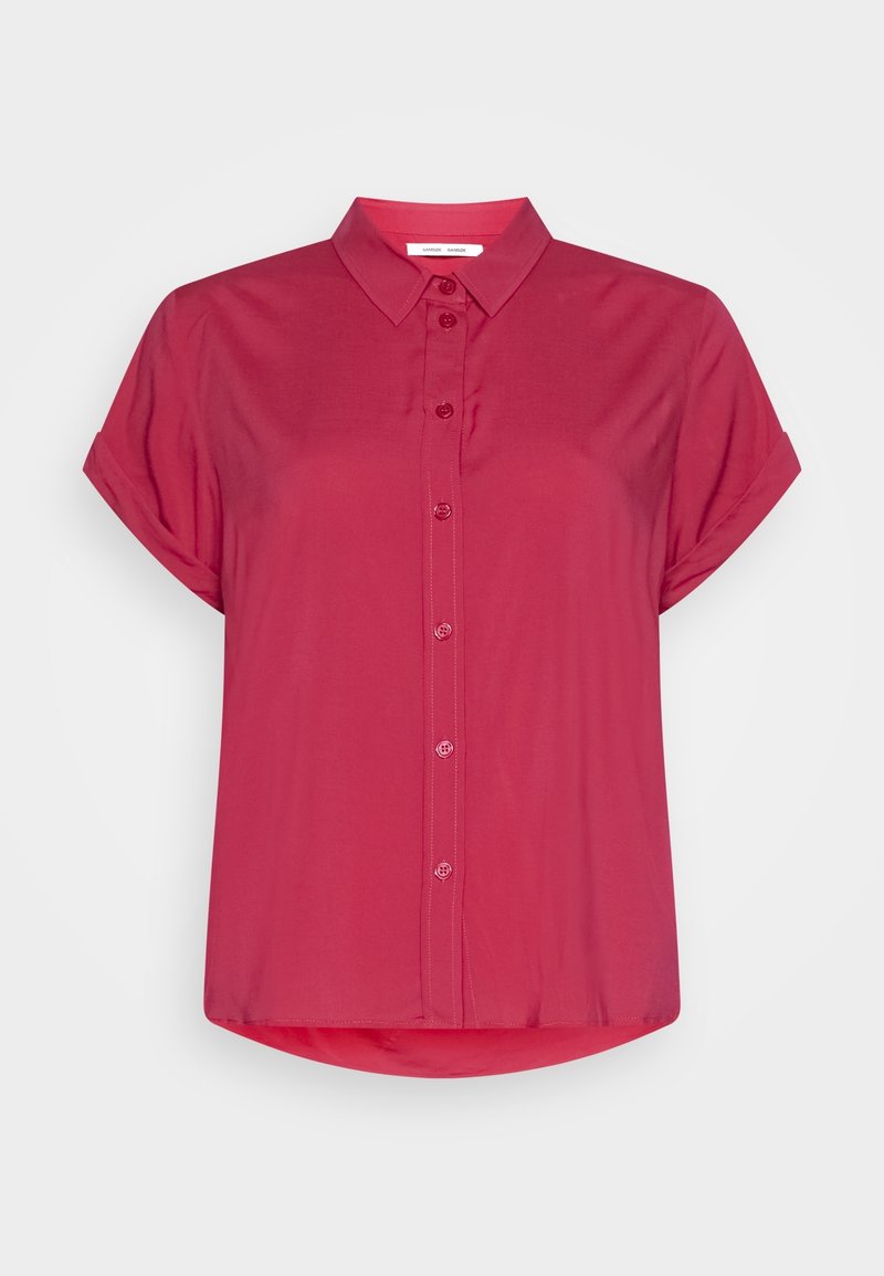 Short-sleeved magenta blouse with a collared neck, button front, and a rounded hem. Made of smooth fabric with a relaxed fit.