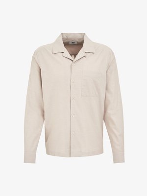 Világos bézs színű, hosszú ujjú ing, gallérral, gombos elülső résszel, egyetlen mellzsebével és sima textúrával. Klasszikus szabású, gombos mandzsettával.