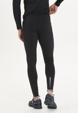 Sorte atletiske leggings med et tætsiddende design, tekstureret stof og refleksive accenter på nederste ben. Har sidelommer.