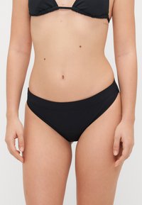 Black bikini bottom featuring a seamless design with a low-rise cut and a smooth texture. No additional patterns or hardware visible.