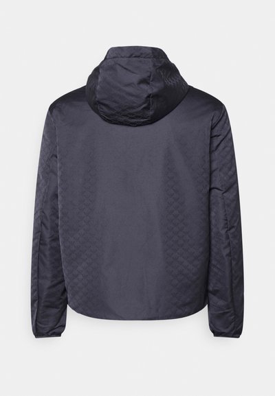 Navy hooded jacket made of smooth fabric. Features a patterned back with a quilted texture and elastic cuffs. Simple, functional design.