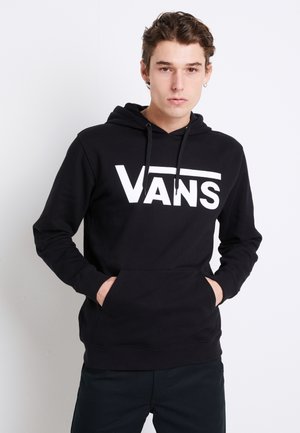 Sudadera negra de algodón con un bolsillo canguro en la parte frontal. Presenta un gran logo blanco de "VANS" en el pecho y capucha con cordones.
