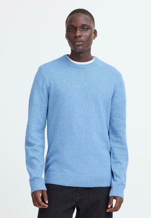 Light blue sweater with long sleeves and a round neck; made from a soft, textured knit; ribbed cuffs and hemline; simple design.