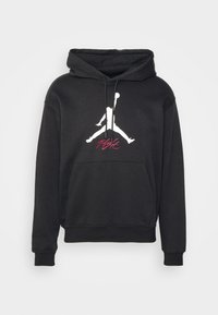 Felpa nera con cappuccio in misto cotone, presenta un logo Jumpman bianco sul petto e la scritta "Flight" in rosso, con una tasca frontale e cappuccio regolabile con cordino.