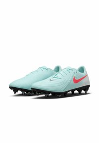 Heledad sinine jalgpallijalats, millel on tekstureeritud ülemine osa, must väljund ja läbipaistvad nupud. Küljel on punane Nike logo.