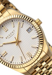 Montre analogique dorée avec un cadran argenté texturé, index heures dorés, affichage de la date à 3 heures, et un bracelet en métal doré.