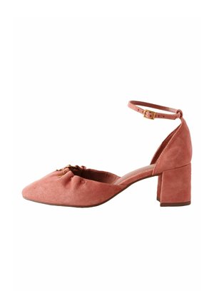 Pink suede women's block heel shoe with ankle strap and pointed toe, featuring small gold buckle and gathered detailing on front.