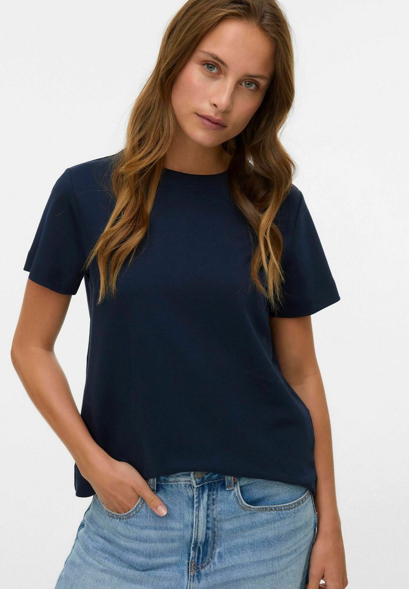 Marineblå kortærmet t-shirt lavet af blødt stof med en afslappet pasform. Har rund halsudskæring og ligger lige under taljen.