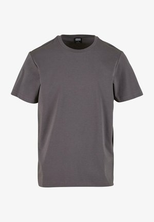 Siva kratka majica s kratkimi rokavi iz mehkega bombažnega materiala, z okroglim izrezom in sproščenim krojem s ravnim robom. Brez vidnih vzorcev.