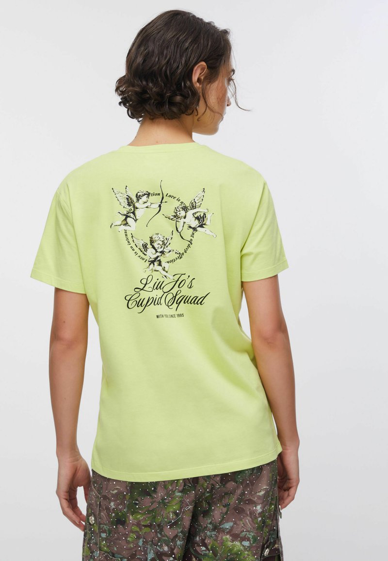 Kortærmet t-shirt i neongul med sort grafik af putter og tekst, med løs pasform og rund halsudskæring.