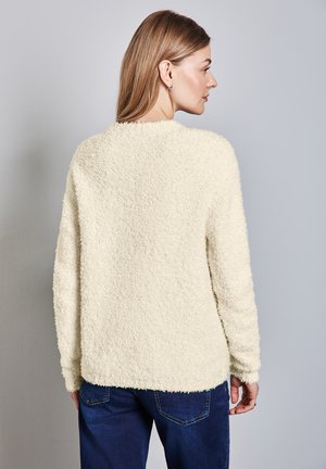 Cream, fluffy sweater with a textured finish, rounded neckline, and long sleeves. Shows back view and slightly curved hem.