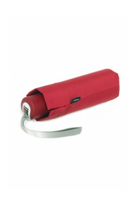 Compact red umbrella with a fabric cover, featuring a circular handle and a silver wrist strap for easy carrying.