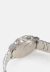 Silver stainless steel watch with a polished finish, chronograph buttons, and a link bracelet. Features a smooth round case back.