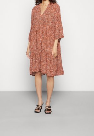 Red floral dress with a deep V-neck, 3/4 bell sleeves, and a flared silhouette, made from lightweight fabric. Accented with a gathered waist.