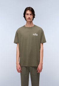 Olive green cotton t-shirt with a round neck and short sleeves, featuring a white logo print on the left chest. Smooth texture.