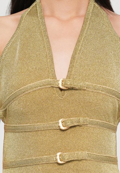 Halter neck top in shimmering gold fabric, featuring a deep V-neckline and three decorative knot details at the waist with subtle texture.