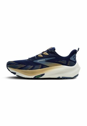 Tumši zilie skriešanas apavi ar elpojošu sietu augšdaļu, zelta akcentiem, biezu baltu vidusdaļu un teksturētu gumijas ārējo zolīti. Rādīts "Brooks" logotips.