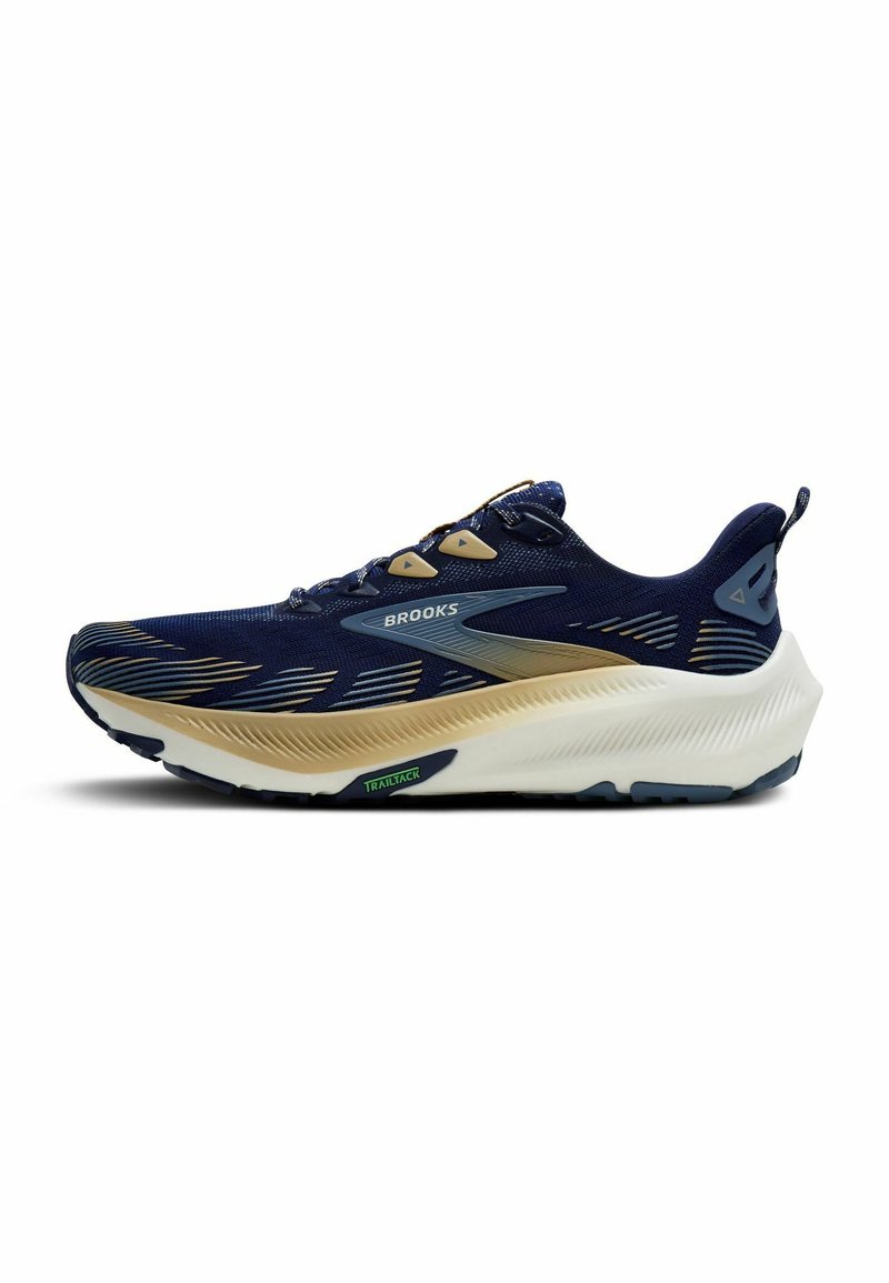 Marineblauwe hardloopschoen met een ademend bovenwerk van mesh, gouden accenten, dikke witte tussenzool en een geprofileerde rubberen buitenzool. "Brooks" logo weergegeven.