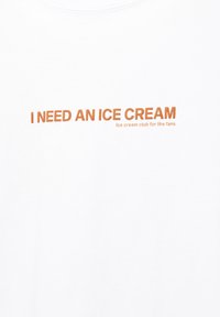 Weiße Baumwoll-T-Shirt mit orangefarbigem Drucktext: "ICH BRAUCHE EINE EISCREME" und "Eiscreme-Club für die Fans" in kleinerer Schrift darunter.