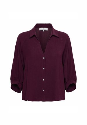 Donkerpaarse blouse met kraag, knoopsluiting aan de voorkant en driekwartlange opgepofte mouwen met elastische manchetten.