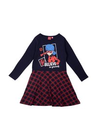 Abito lungo a maniche con stampa di un personaggio dei cartoni animati in navy e la scritta "CREDI in te stesso." La gonna presenta un motivo a quadretti rossi e navy.