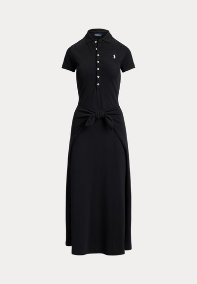 Black short-sleeve polo dress with white buttons, a tied waist detail, and a small white embroidered logo on the chest.