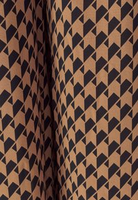 Brown fabric featuring a geometric pattern of black shapes resembling arrows or chevrons, evenly spaced and oriented in multiple directions.