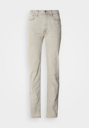 Jeans in denim beige con design a gamba dritta, modello a cinque tasche e chiusura con bottone. Presenta una texture sottile e accenti di cuciture minime.