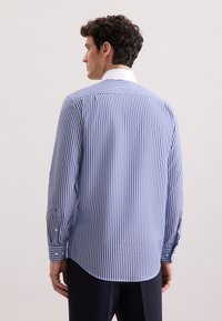 Camicia a maniche lunghe a righe blu e bianche, con colletto classico, polsini abbottonati e orlo curvo, realizzata in tessuto morbido.