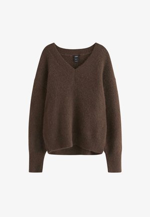 Ruskea neulepaita, jossa on V-pääntie, laskeutuvat olkapäät ja pitkät hihat. Pehmeä rakenne ja rento istuvuus ribbausvaroilla hihoissa ja helmassa.