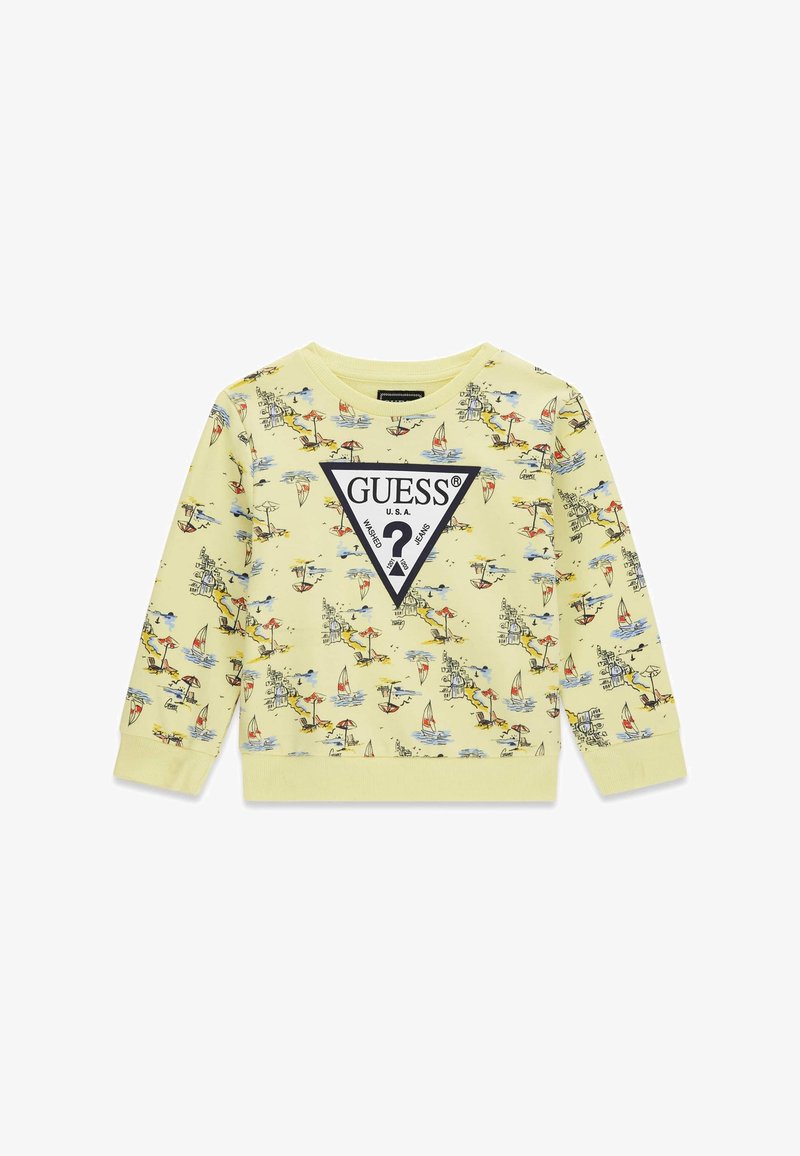 Sweat-shirt jaune à manches longues pour enfants avec des scènes de plage colorées et un grand logo triangle Guess noir et blanc sur le devant.