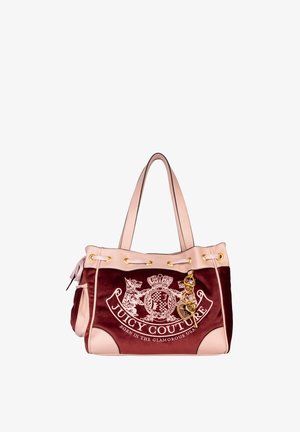 Maroon velvet handbag with light pink synthetic leather accents, gold grommets, and chain detail featuring the "Juicy Couture" logo.