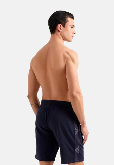 Shorts de bain navy en matériau léger, dotés d'une taille élastique et d'accents latéraux avec un design de logo subtil.