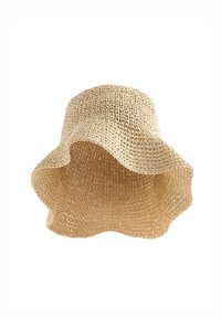 Chapeau de soleil en paille tressée couleur naturelle avec un large bord souple et ondulé pour la protection contre le soleil.